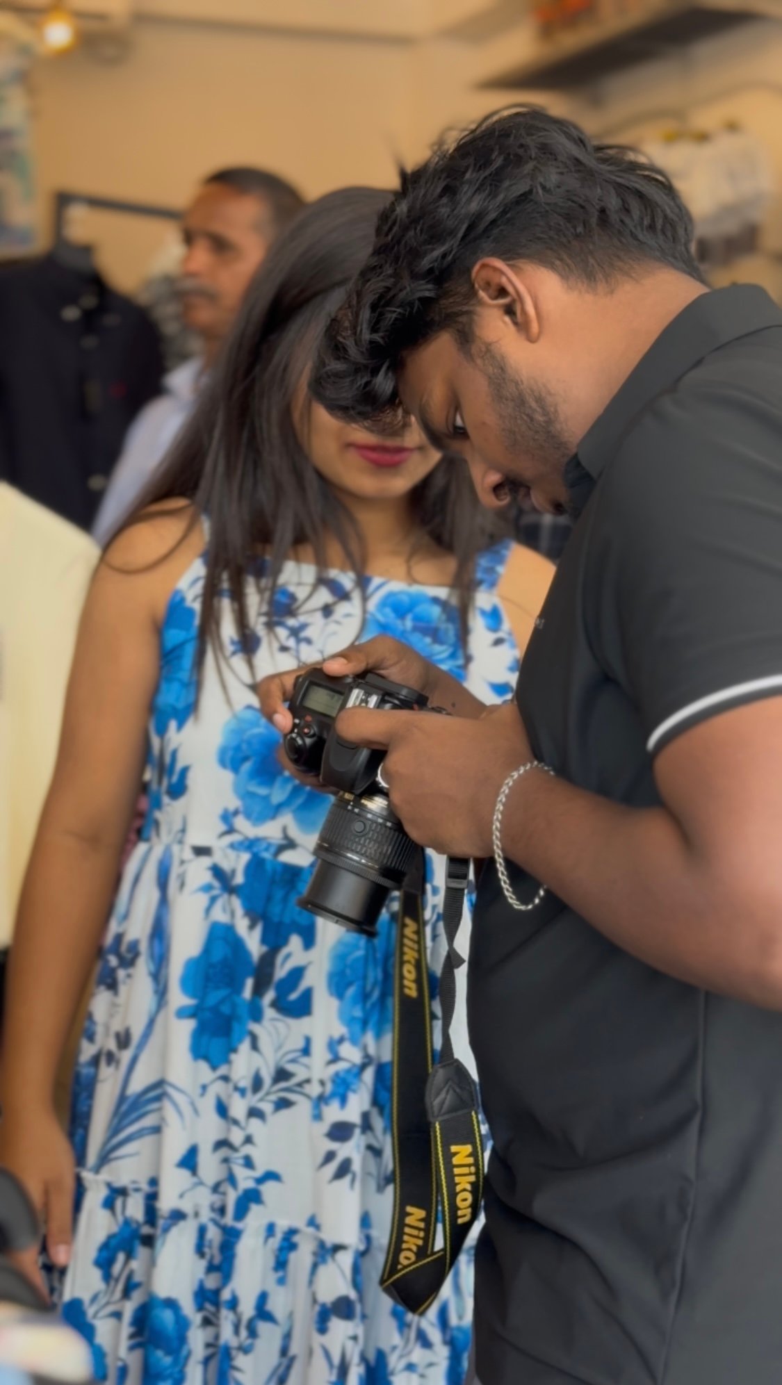 On-site fashion shoot — photographer reviewing capture with model